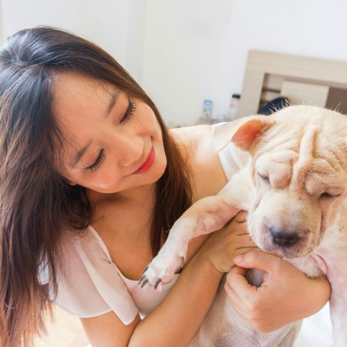 woman holding a puppy